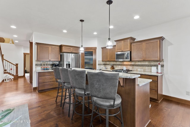 13408 E Copper River Ln, Spokane, WA 99206 - kitchen featuring stainless steel appliances, backsplash, dark wood-style floors, a kitchen bar, and recessed lighting