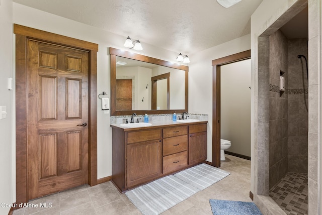 13408 E Copper River Ln, Spokane, WA 99206 - bathroom featuring double vanity, a tile shower, and tile patterned floors