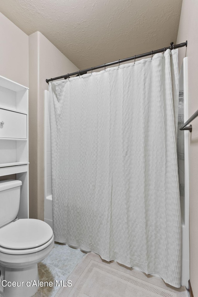 13408 E Copper River Ln, Spokane, WA 99206 - bathroom with shower / bathtub combination with curtain, a textured ceiling, and tile patterned flooring