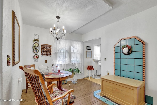 1505 N 3rd, Coeur Dalene, ID 83814 - dining area with a chandelier, light wood-style flooring, and a textured ceiling