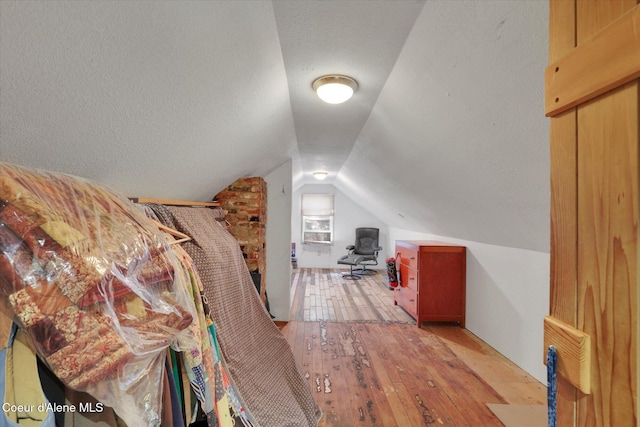 1505 N 3rd, Coeur Dalene, ID 83814 - bedroom with lofted ceiling, hardwood / wood-style flooring, and a textured ceiling