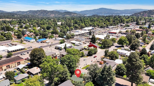 1505 N 3rd, Coeur Dalene, ID 83814 - aerial view of residential area with a mountain backdrop and a heavily wooded area