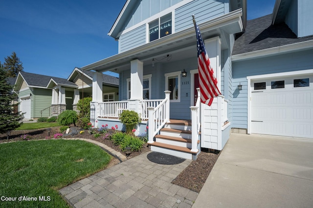 1121 E Indiana Ave, Coeur Dalene, ID 83814 - entrance to property with a porch, a garage, board and batten siding, a shingled roof, and a lawn