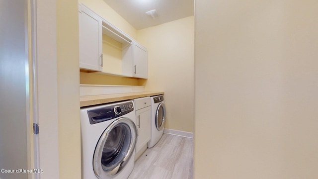 1121 E Indiana Ave, Coeur Dalene, ID 83814 - laundry area with independent washer and dryer, cabinet space, and light wood-style floors