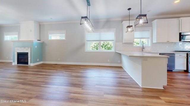 1121 E Indiana Ave, Coeur Dalene, ID 83814 - kitchen with stainless steel appliances, white cabinets, a peninsula, light countertops, and decorative backsplash