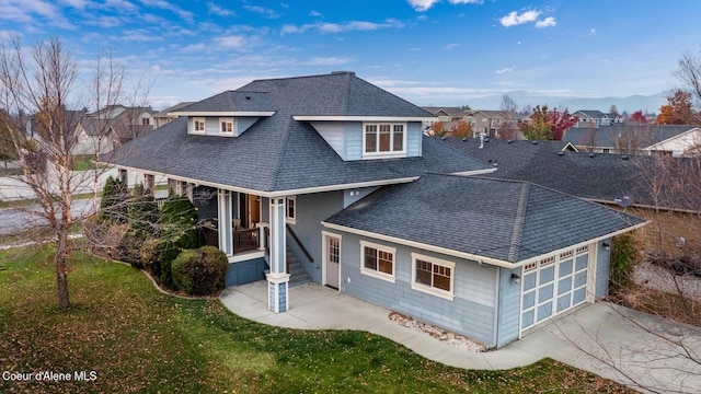 2848 N O Connor Blvd, Post Falls, ID 83854 - view of front of home with roof with shingles, concrete driveway, a garage, a residential view, and covered porch