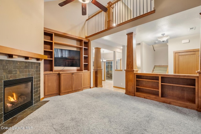 2848 N O Connor Blvd, Post Falls, ID 83854 - unfurnished living room with a ceiling fan, a fireplace, carpet flooring, ornate columns, and stairs