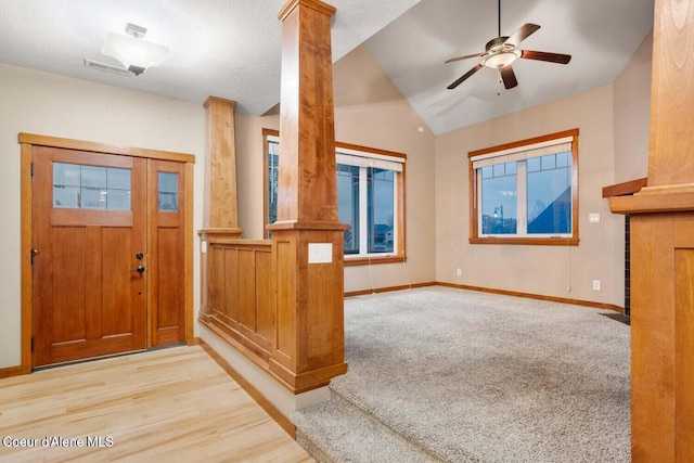 2848 N O Connor Blvd, Post Falls, ID 83854 - foyer entrance featuring ornate columns, vaulted ceiling, ceiling fan, carpet flooring, and wood finished floors