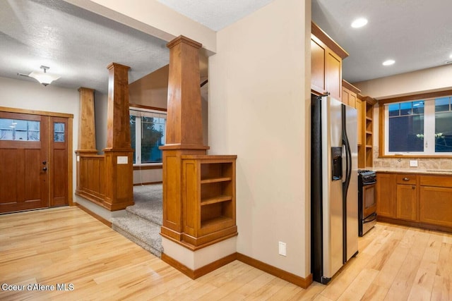 2848 N O Connor Blvd, Post Falls, ID 83854 - kitchen with fridge with ice dispenser, ornate columns, gas range, light wood-type flooring, and open shelves