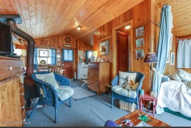 16946 E Jds E Dock 27, Bayview, ID 83803 - living area featuring carpet floors, lofted ceiling, wooden walls, and wooden ceiling