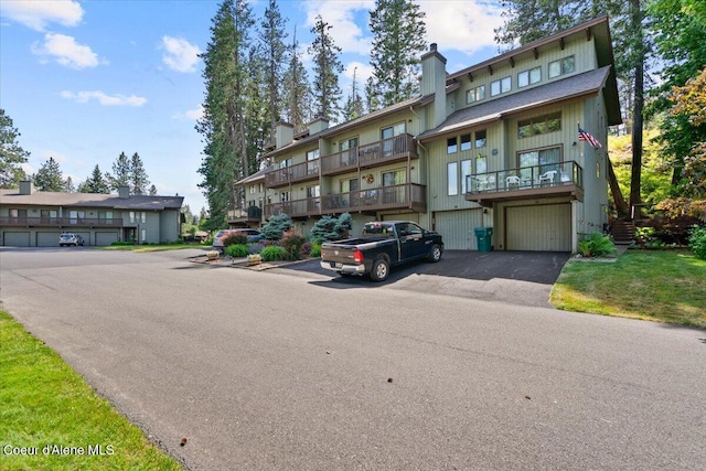 5276 W Racquet Rd Unit 9, Rathdrum, ID 83858 - view of front of property featuring a chimney, driveway, and an attached garage