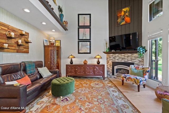 5276 W Racquet Rd Unit 9, Rathdrum, ID 83858 - living room featuring a fireplace, recessed lighting, wood finished floors, and a towering ceiling