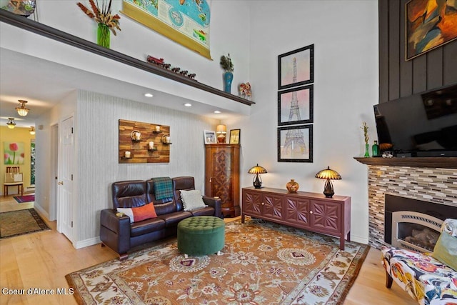5276 W Racquet Rd Unit 9, Rathdrum, ID 83858 - living area with wood finished floors, a high ceiling, and a fireplace