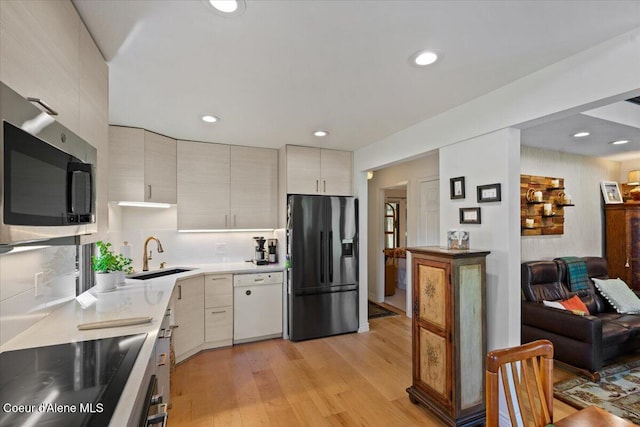 5276 W Racquet Rd Unit 9, Rathdrum, ID 83858 - kitchen with black appliances, light wood-style flooring, light countertops, recessed lighting, and modern cabinets