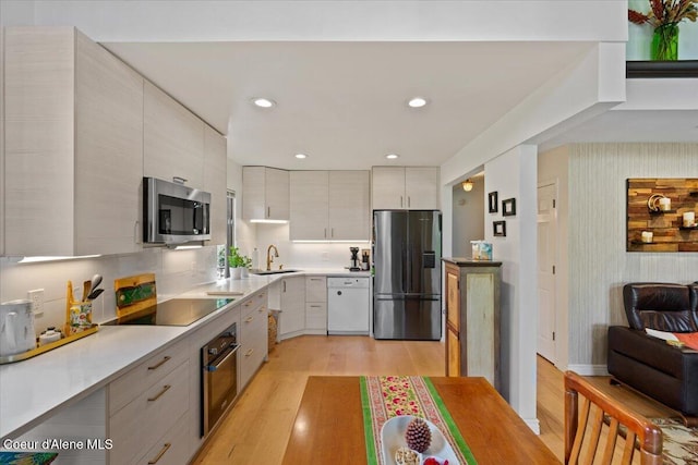 5276 W Racquet Rd Unit 9, Rathdrum, ID 83858 - kitchen with appliances with stainless steel finishes, light wood finished floors, light countertops, modern cabinets, and recessed lighting