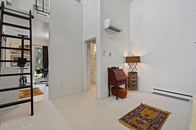 5276 W Racquet Rd Unit 9, Rathdrum, ID 83858 - bedroom featuring baseboard heating, an AC wall unit, carpet floors, a high ceiling, and connected bathroom