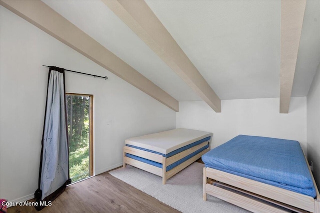 5276 W Racquet Rd Unit 9, Rathdrum, ID 83858 - bedroom featuring wood finished floors and beam ceiling
