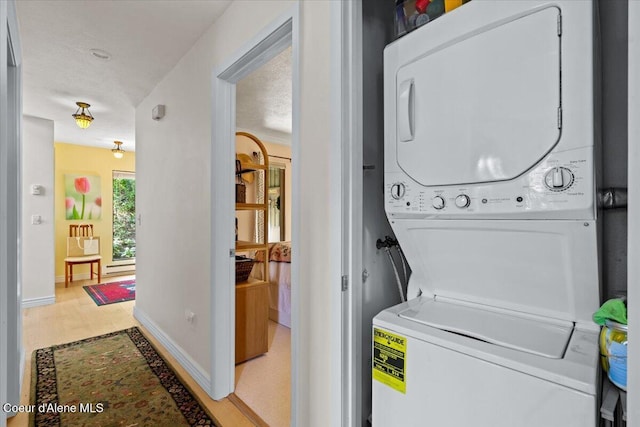 5276 W Racquet Rd Unit 9, Rathdrum, ID 83858 - washroom with stacked washer / dryer and baseboards