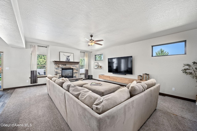 2499 N N Side Saddle Ln, Post Falls, ID 83854 - carpeted living room with a textured ceiling, ceiling fan, and a fireplace