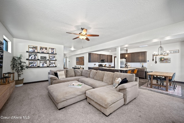 2499 N N Side Saddle Ln, Post Falls, ID 83854 - living area featuring light carpet, a ceiling fan, a chandelier, and a textured ceiling