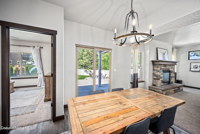 2499 N N Side Saddle Ln, Post Falls, ID 83854 - dining room with a chandelier, healthy amount of natural light, a fireplace, and wood finished floors