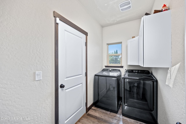 2499 N N Side Saddle Ln, Post Falls, ID 83854 - washroom with cabinet space, a textured wall, washer and dryer, and wood finished floors