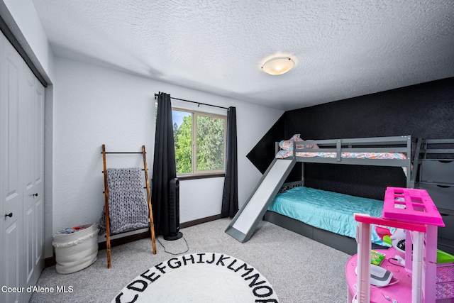 2499 N N Side Saddle Ln, Post Falls, ID 83854 - bedroom featuring a closet, carpet floors, and a textured ceiling