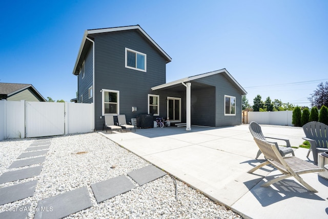 2499 N N Side Saddle Ln, Post Falls, ID 83854 - back of property with a gate and a patio