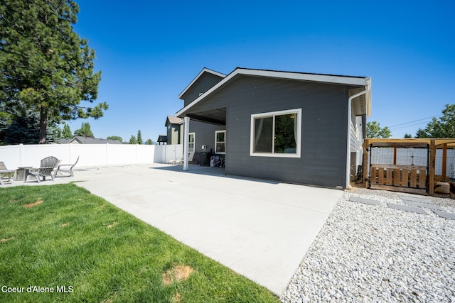 2499 N N Side Saddle Ln, Post Falls, ID 83854 - rear view of house featuring a patio area and a fire pit