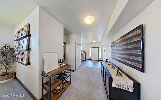 2499 N N Side Saddle Ln, Post Falls, ID 83854 - hallway featuring carpet floors, a textured ceiling, and stairs