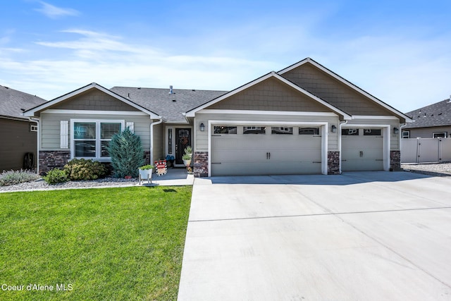 3631 N Britton Rd, Post Falls, ID 83854 - view of front of property with an attached garage, stone siding, and concrete driveway