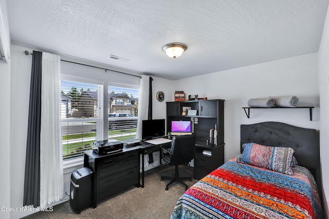 3631 N Britton Rd, Post Falls, ID 83854 - carpeted bedroom with multiple windows, a textured ceiling, and an office area