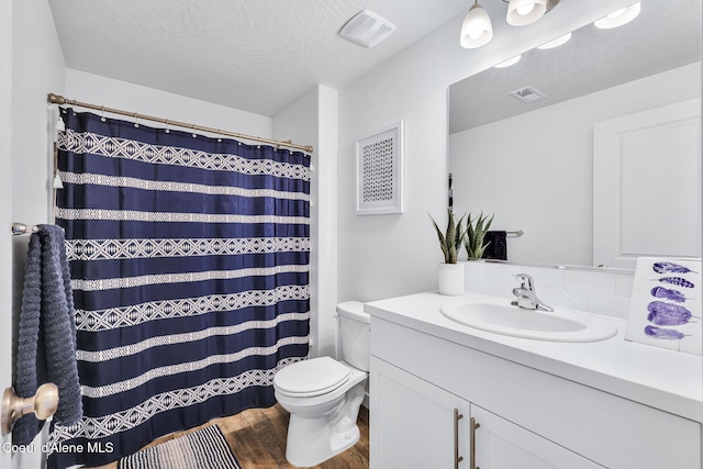 3631 N Britton Rd, Post Falls, ID 83854 - full bathroom with vanity, wood finished floors, a textured ceiling, backsplash, and curtained shower