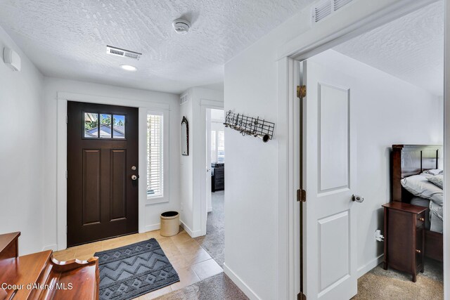 3631 N Britton Rd, Post Falls, ID 83854 - entrance foyer featuring a textured ceiling and light tile patterned flooring