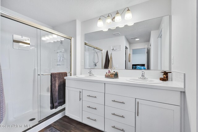 3631 N Britton Rd, Post Falls, ID 83854 - bathroom with double vanity, a stall shower, and wood finished floors