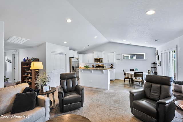 3631 N Britton Rd, Post Falls, ID 83854 - living room featuring lofted ceiling, light colored carpet, and recessed lighting