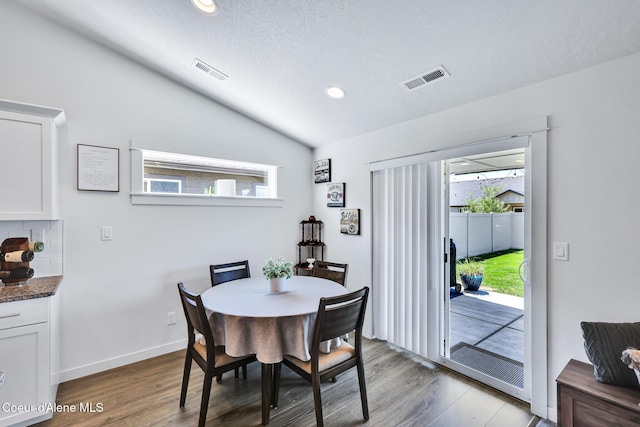 3631 N Britton Rd, Post Falls, ID 83854 - dining area with lofted ceiling, plenty of natural light, wood finished floors, recessed lighting, and a textured ceiling