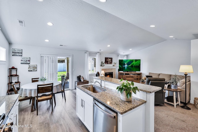 3631 N Britton Rd, Post Falls, ID 83854 - kitchen featuring appliances with stainless steel finishes, a center island with sink, white cabinetry, recessed lighting, and lofted ceiling