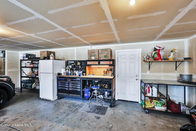 3631 N Britton Rd, Post Falls, ID 83854 - garage featuring a workshop area and freestanding refrigerator