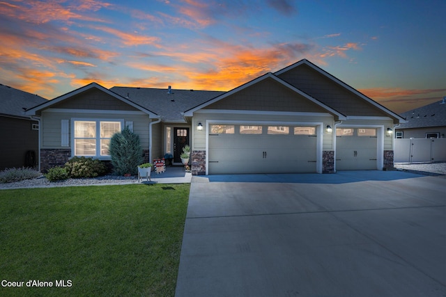 3631 N Britton Rd, Post Falls, ID 83854 - ranch-style home with stone siding, a garage, and driveway