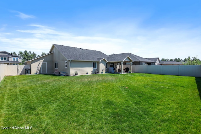 3631 N Britton Rd, Post Falls, ID 83854 - back of property featuring a fenced backyard, board and batten siding, and roof with shingles
