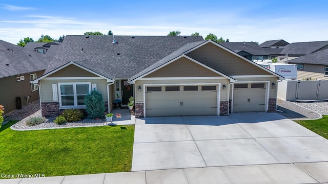 3631 N Britton Rd, Post Falls, ID 83854 - craftsman-style home featuring stone siding, an attached garage, driveway, a shingled roof, and a gate