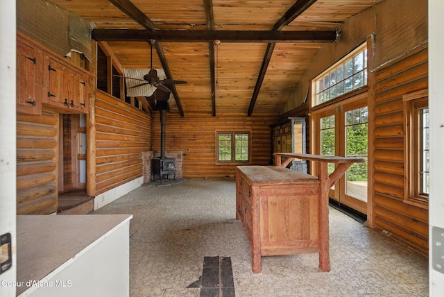 527 W Seneacquoteen, Priest River, ID 83856 - unfurnished office with log walls, a wooden ceiling with exposed beams, a wood stove, high vaulted ceiling, and ceiling fan