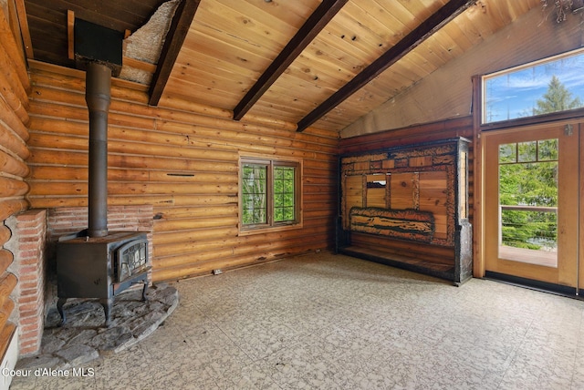 527 W Seneacquoteen, Priest River, ID 83856 - unfurnished living room featuring a wood stove, plenty of natural light, wooden ceiling, and log walls