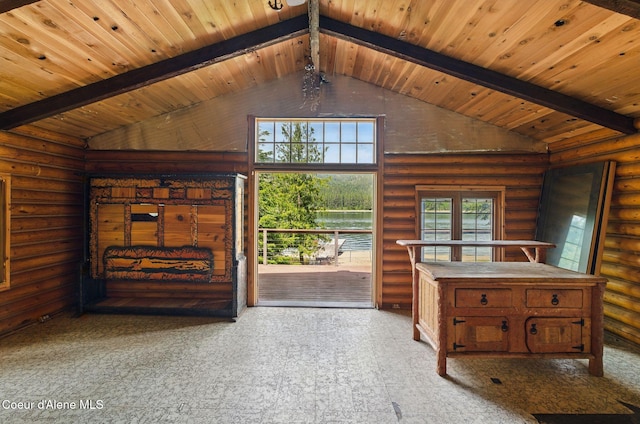 527 W Seneacquoteen, Priest River, ID 83856 - unfurnished living room featuring a wood ceiling with exposed beams, rustic walls, and high vaulted ceiling