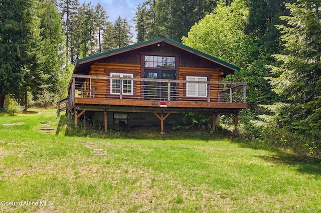 527 W Seneacquoteen, Priest River, ID 83856 - view of front of property with a front lawn, a deck, and log siding