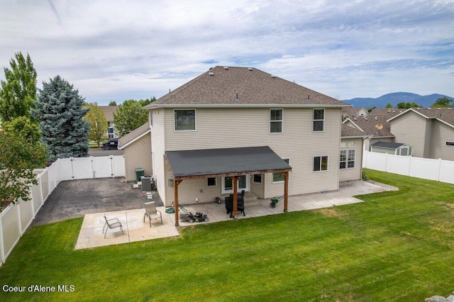 8136 Salmonberry Lp, Hayden, ID 83835 - rear view of property featuring a gate, a fenced backyard, a patio area, and a deck with mountain view