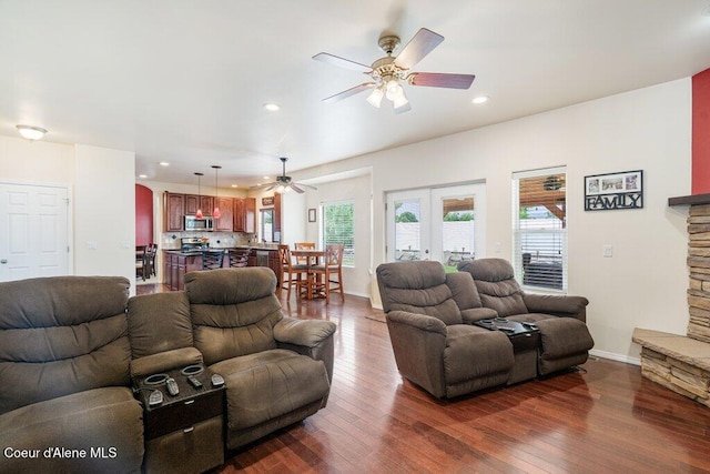 8136 Salmonberry Lp, Hayden, ID 83835 - living area featuring a ceiling fan, dark wood-style floors, arched walkways, and recessed lighting
