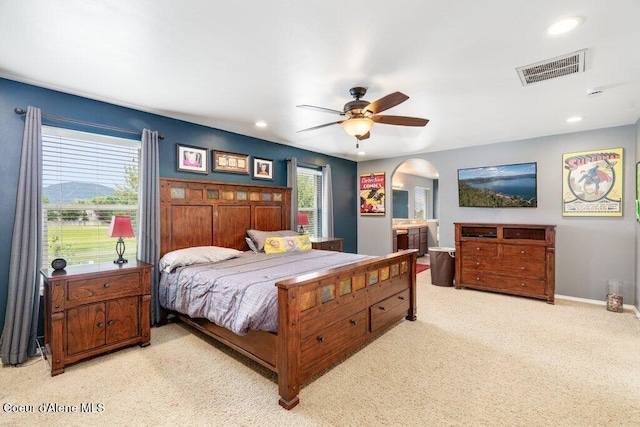 8136 Salmonberry Lp, Hayden, ID 83835 - bedroom with arched walkways, multiple windows, light carpet, recessed lighting, and ceiling fan