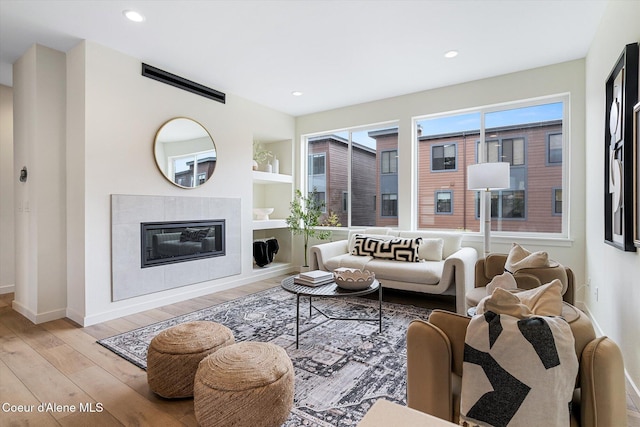 2756 W Lumber Ln Unit 7, Coeur Dalene, ID 83814 - living area with wood finished floors, recessed lighting, built in features, and a tiled fireplace